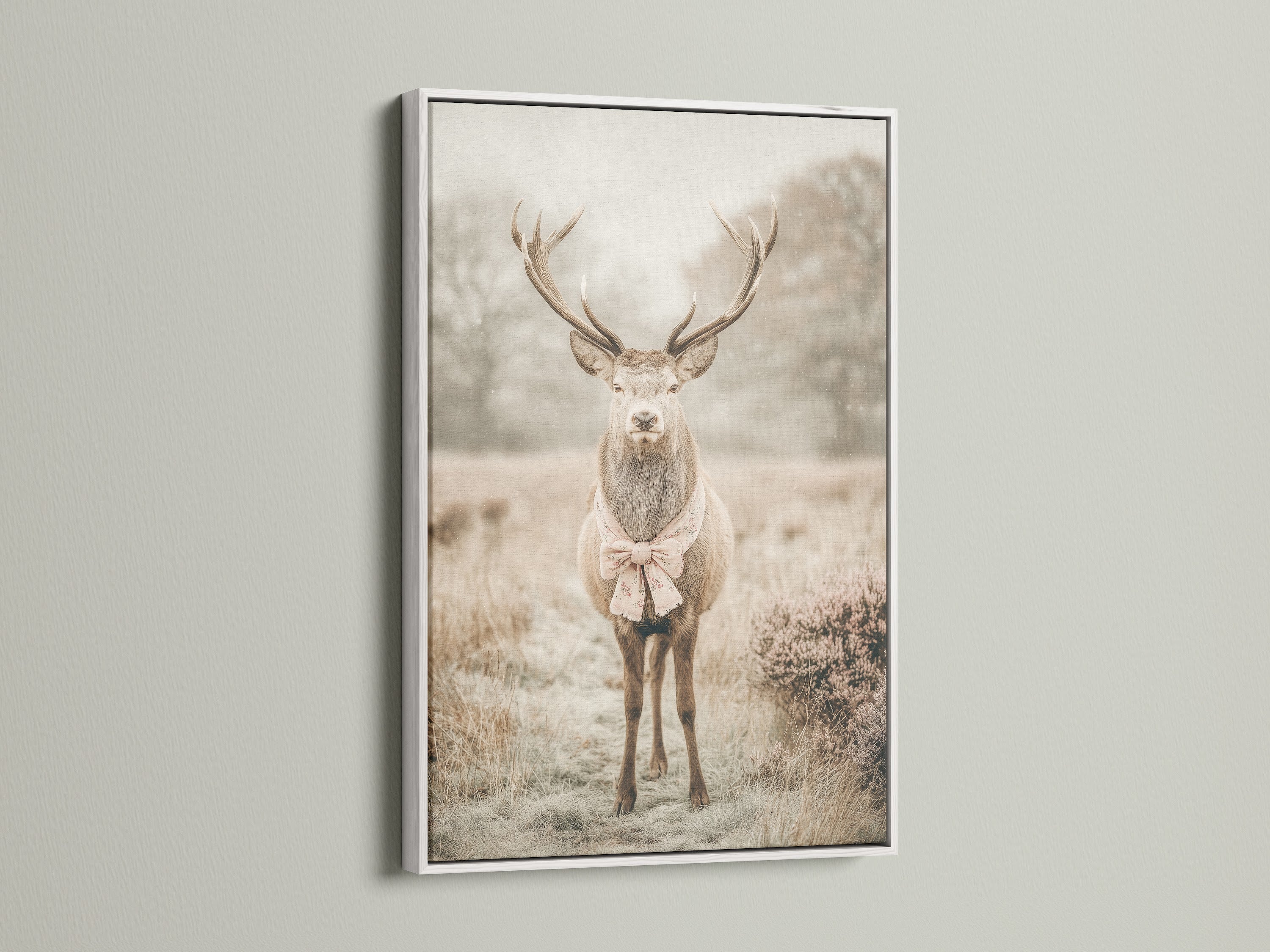 A deer artwork with a bow tie is presented in a white frame. The white frame offers a clean and modern look. This whimsical animal art is perfect for nursery wall decor. It adds a touch of vintage charm to any space. The artwork complements country farmhouse or eclectic decor styles. The primary color is beige.