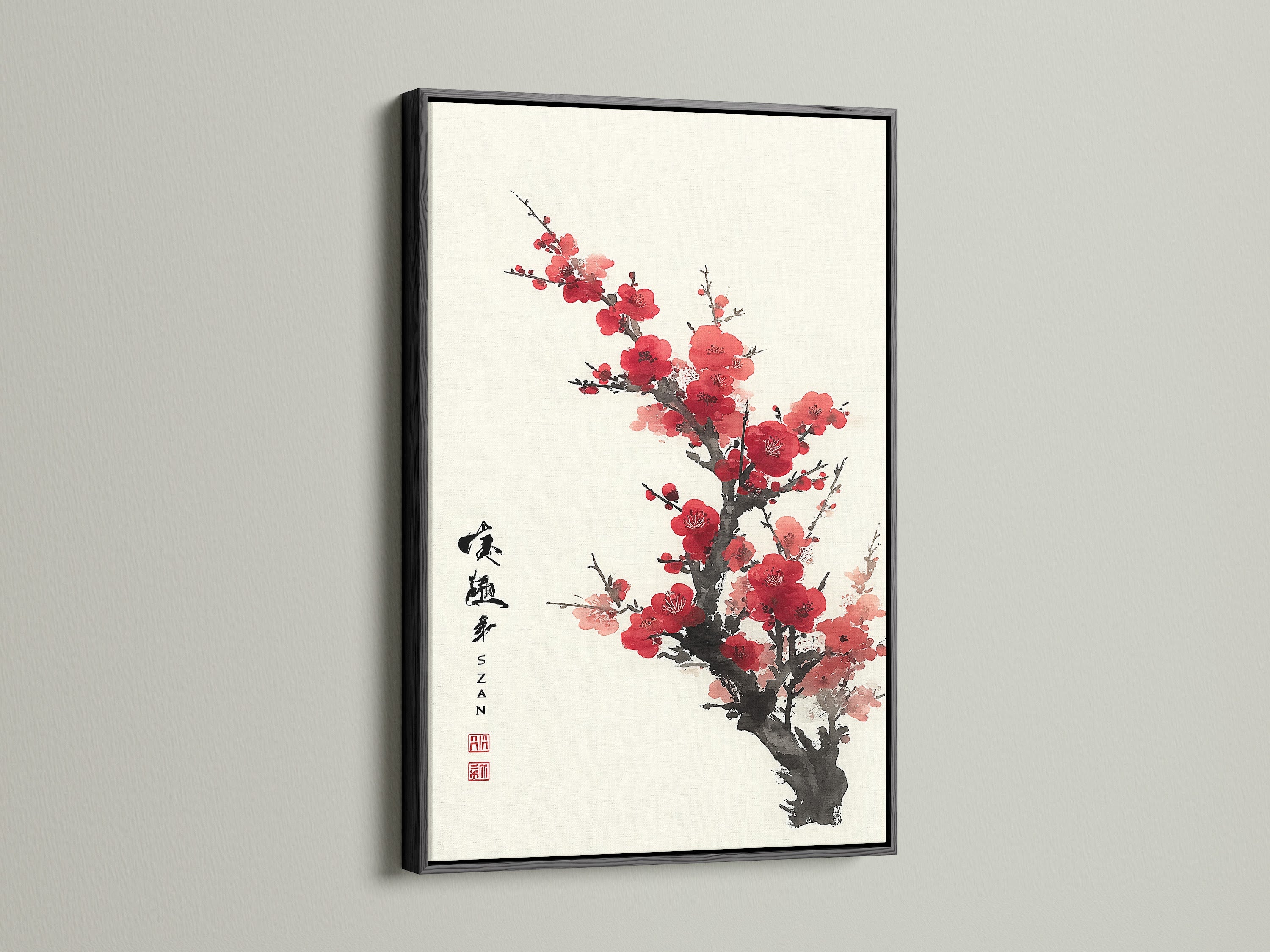 Artwork featuring red blossoms in a black frame. The dark frame creates a striking contrast. The art is hung on a white wall. Make a statement with framed art. Explore our collection of framed artwork. Find the perfect piece for your home or office.