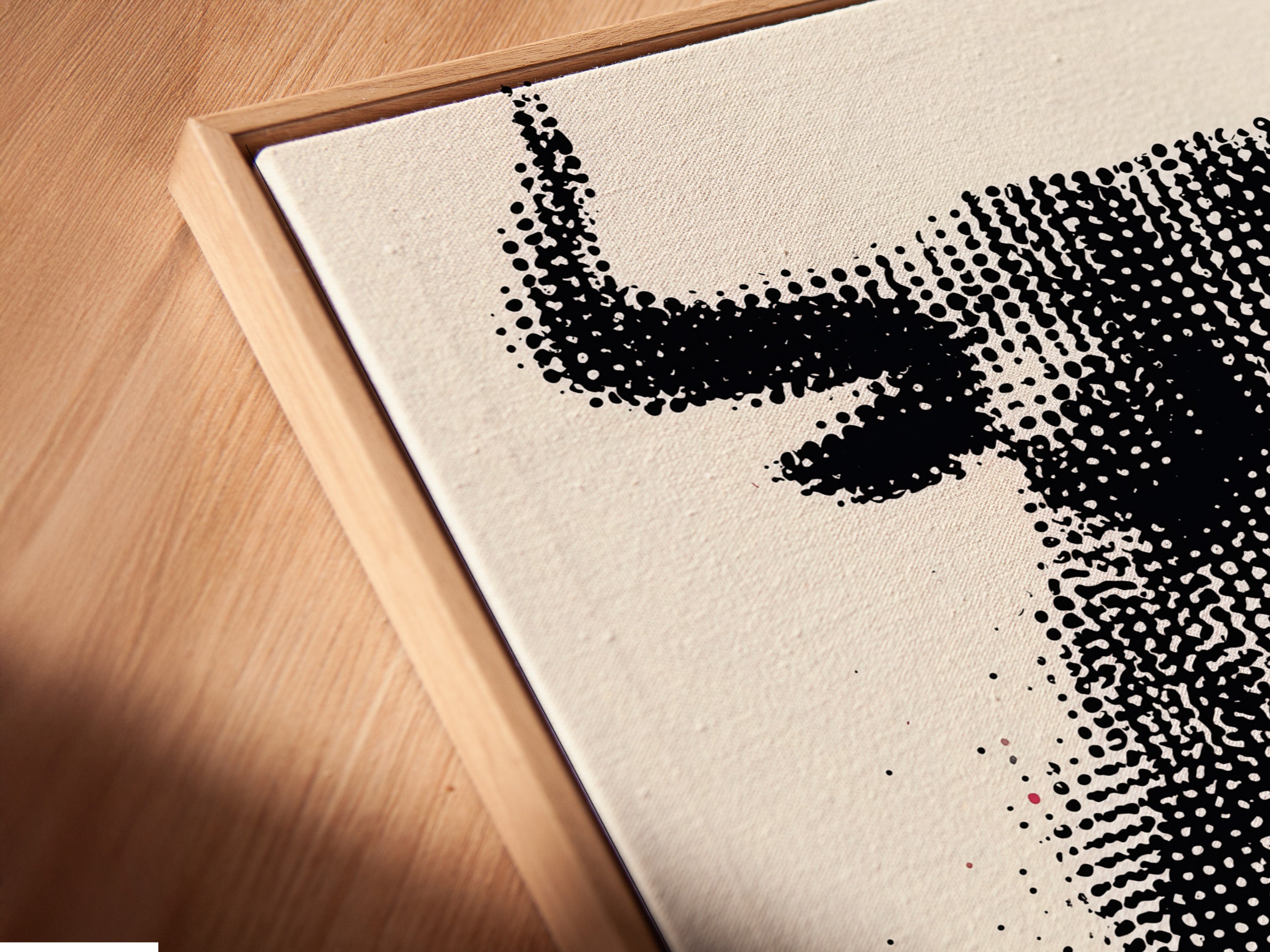 A close-up angled view of a canvas print in a floating frame. The bull artwork features a modern halftone print. The floating frame adds depth and dimension. This unique framing style enhances the artwork's contemporary look. It's perfect for creating a gallery-like feel in your home or office. Elevate your wall art today.