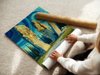 A woman is carefully rolling a fine art poster paper. The paper features a Celtic mystical landscape artwork. The artwork shows an ancient stone circle beneath a swirling sky. This poster is ideal for those who appreciate spiritual artwork.