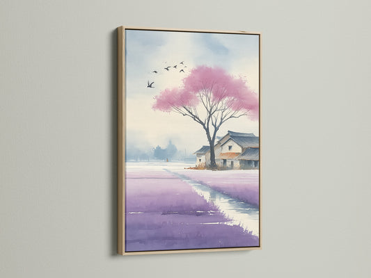 Close up of a Japanese Cherry Blossom artwork in an oak frame on a white wall. The watercolor canvas art captures a violet lavender field. It is perfect wall decor for living rooms bedrooms or offices. The Asian landscape evokes a sense of calm and zen.