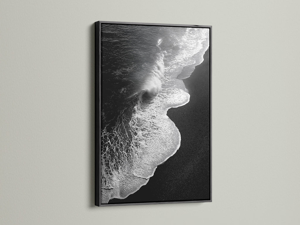 This artwork features a black and white ocean wave. It is showcased in a sleek black frame. A striking beach canvas print. It suits modern and nautical styles. Its monochrome art adds sophistication to any room. Perfect for living room wall art. Enhance your space with this coastal decor masterpiece.