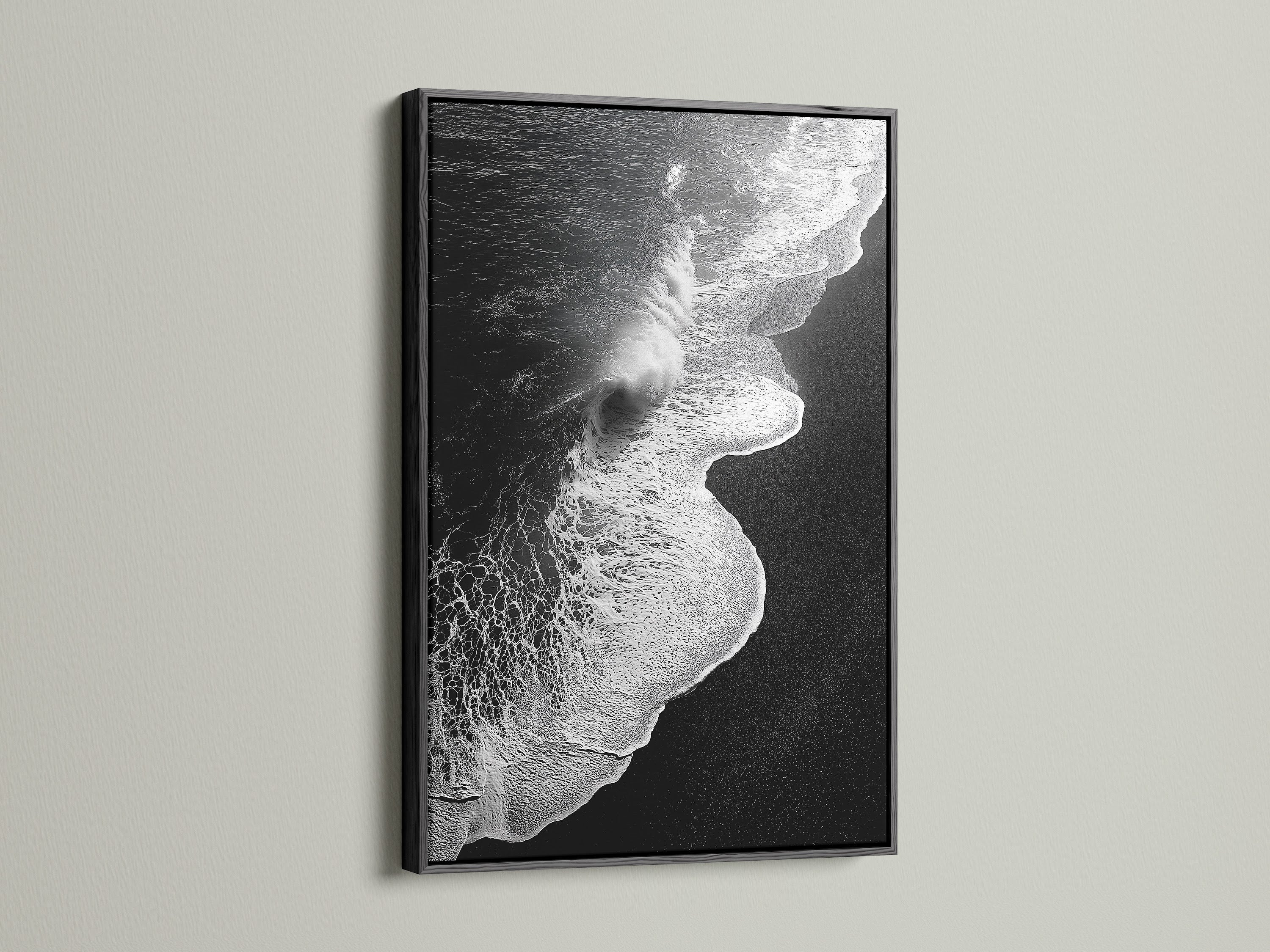 This artwork features a black and white ocean wave. It is showcased in a sleek black frame. A striking beach canvas print. It suits modern and nautical styles. Its monochrome art adds sophistication to any room. Perfect for living room wall art. Enhance your space with this coastal decor masterpiece.