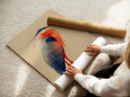 A woman carefully rolling a fine art poster paper. The heron artwork is printed on high-quality paper. Perfect for nature lovers seeking a bird print. This fine art poster paper ensures vibrant colors. It's an ideal gift for bird watchers. The paper makes the avian artwork shine.