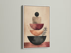 The image displays an abstract stacking canvas print with a white frame. The terracotta geometric shapes and neutral tones offer a modern touch. It is suitable for boho and minimalist art styles. It can brighten up any living room or office.