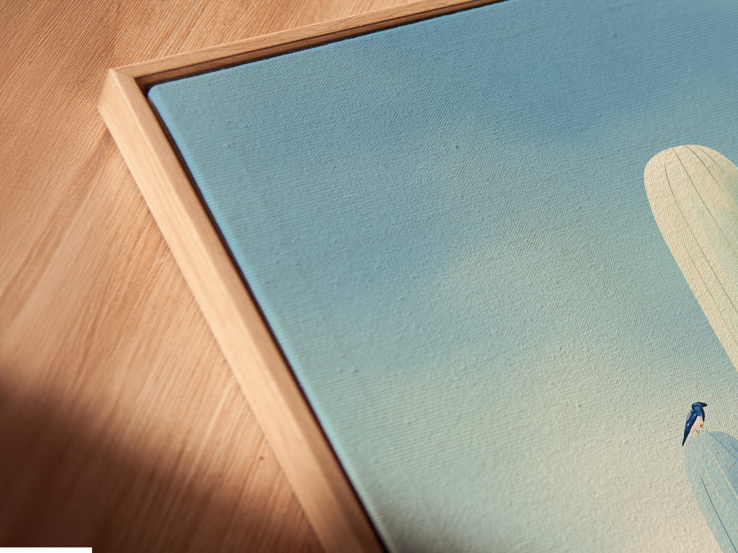 Angled close up shows a canvas print in a floating frame. It offers a modern way to display southwestern art. The floating frame enhances the teal wall art. This blue art print will elevate your home's style.
