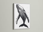 Humpback Whale art print with a white frame. This nautical wall art brings coastal charm. Ideal for homeowners and renters. This marine canvas art enhances studios and coastal cafes. Its primary color is black and secondary color is white