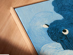 A close-up angled view shows a canvas print in a floating frame. The abstract wave artwork highlights the modern swirl art. The blue ocean print appears to float. This framing style adds depth and dimension. The piece enhances your home decor effortlessly.