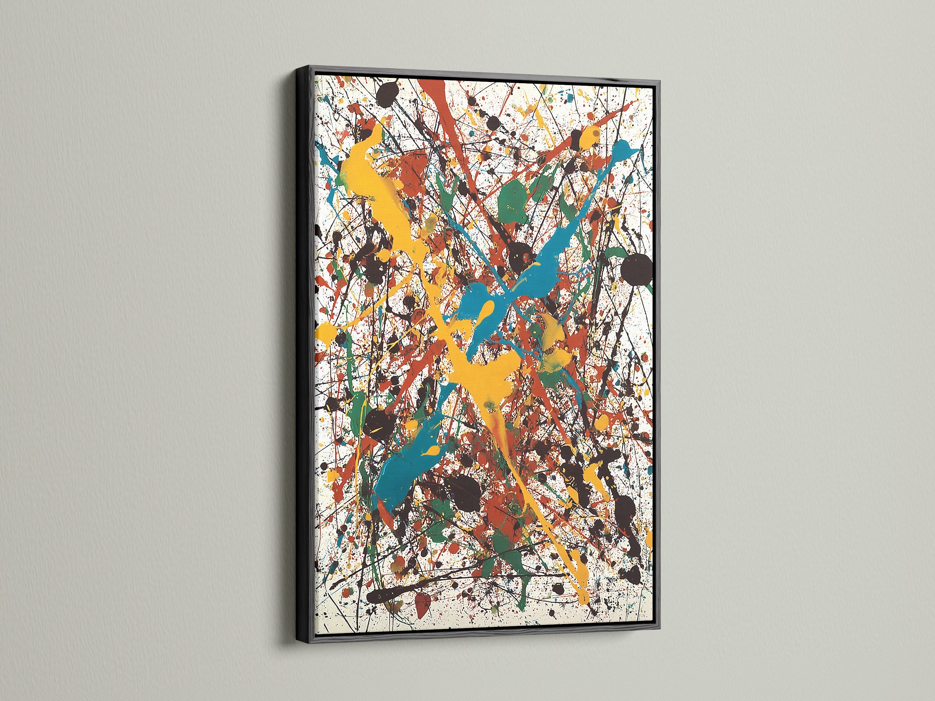 An abstract artwork is presented in a classic black frame. The artwork features splatters of yellow teal red green and black paint. The black frame adds a touch of sophistication. Discover timeless elegance for your cherished prints.