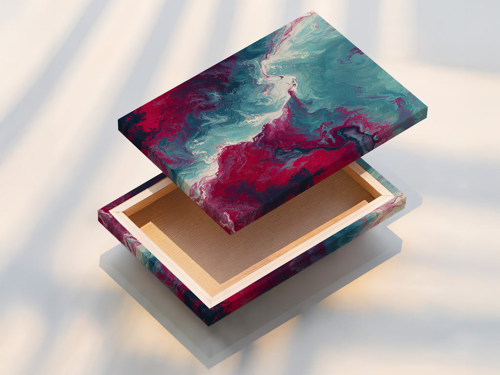 This is a stretched canvas print of abstract fluid artwork. The teal and pink hues blend seamlessly creating a captivating marble swirl. The stretched canvas provides a clean and modern look. Perfect for adding a contemporary touch to any living space or office.