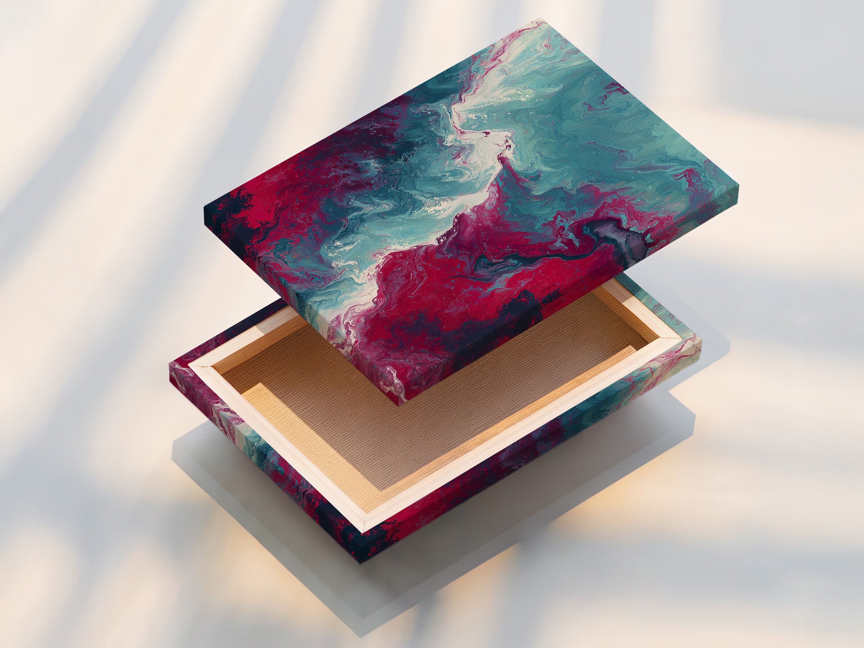 This is a stretched canvas print of abstract fluid artwork. The teal and pink hues blend seamlessly creating a captivating marble swirl. The stretched canvas provides a clean and modern look. Perfect for adding a contemporary touch to any living space or office.