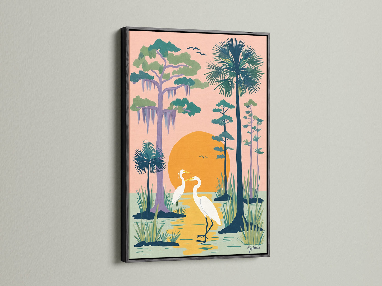 Heron artwork displayed in a black frame. The heron canvas print features two white herons in their natural habitat. The peach sky illuminates the artwork. Add this tropical wall art to your bedroom decor. Perfect for nature lovers.