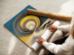 A woman carefully rolls a fine art poster paper. The high-quality paper ensures a vibrant long-lasting artwork. Poster paper is a versatile and affordable artwork option. Ideal for modern art prints. Learn about fine art poster paper options. See how to prepare your artwork.