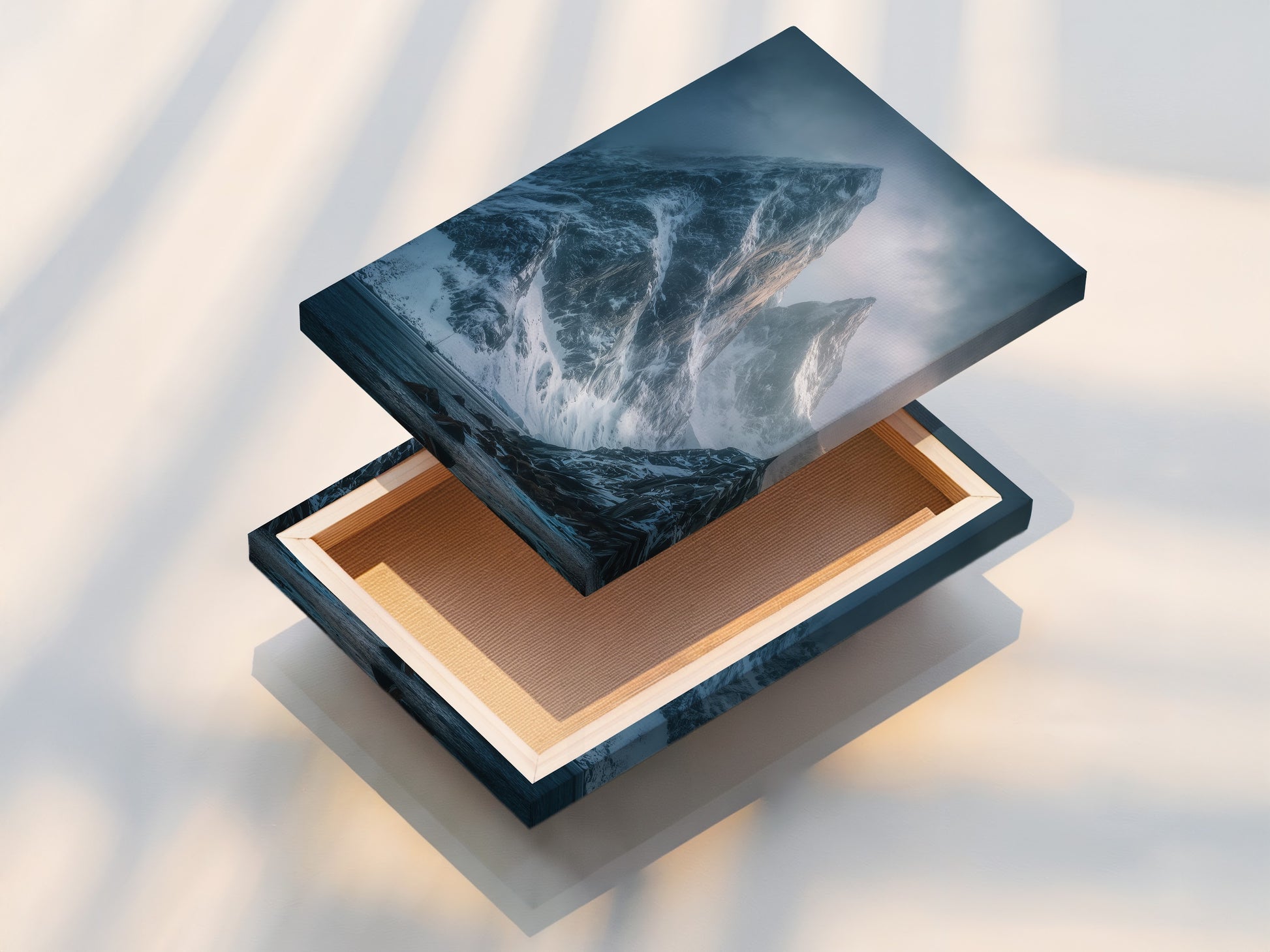 A stretched canvas print displays stunning coastal mountain range art. The snow capped peaks and moody landscape create a captivating visual. Perfect as living room or office wall art.