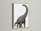 Dinosaur wall art featuring a minimalist brontosaurus canvas print. It is perfect modern nursery decor for a kids room. The artwork has an oak frame. Black and white animal art fits minimalist and Scandinavian styles.