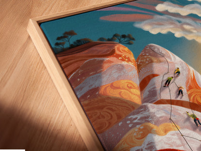 A close up angled view shows a canvas print in a floating frame. The mountain climbing artwork is displayed beautifully. It is perfect for adding adventure to your walls. This sporty wall decor is great for a home gym. It is a thoughtful gift for climbers and fitness lovers.