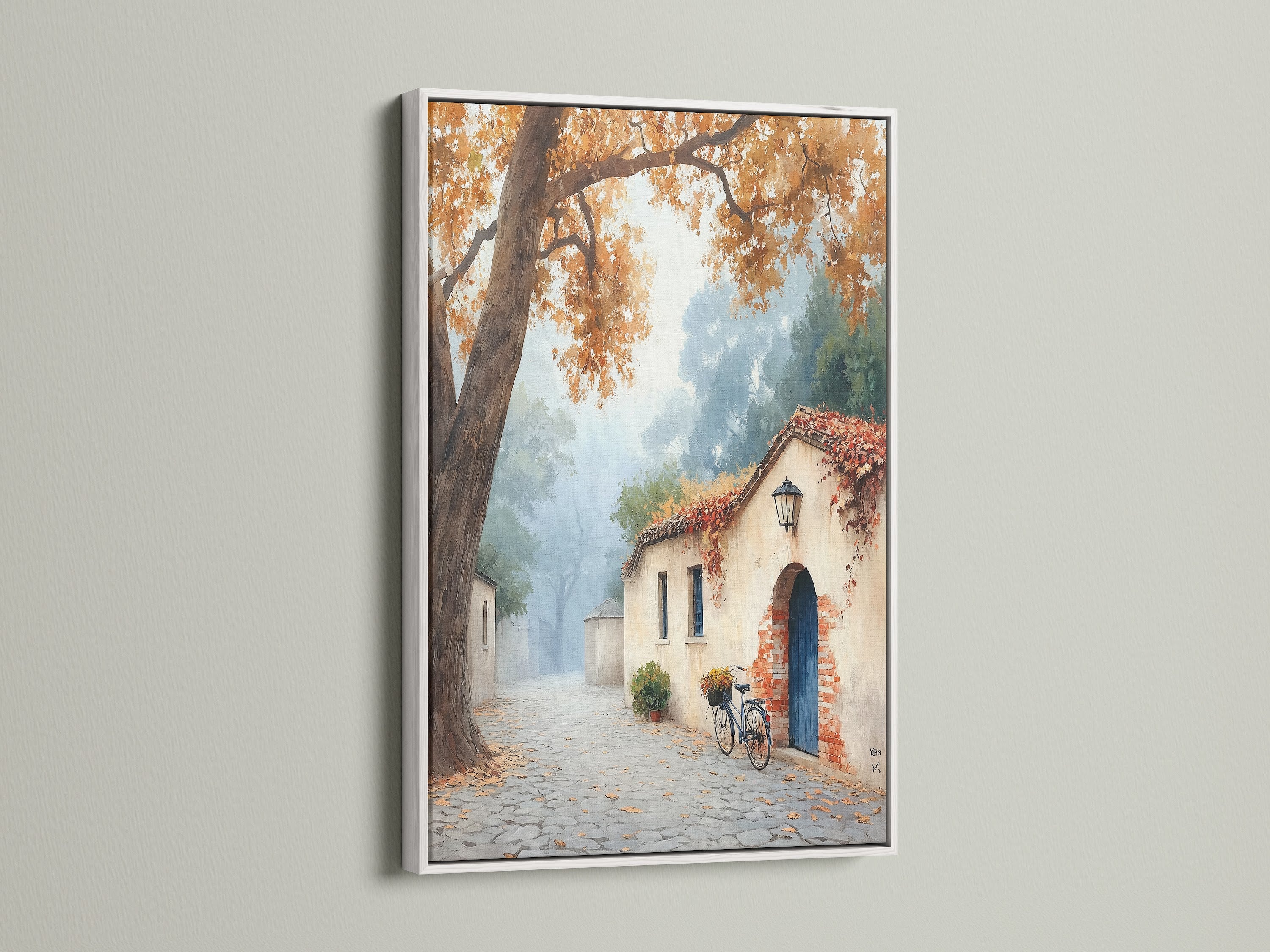 This artwork shows a white framed Italian Village Canvas Print. The Tuscan Wall Art features an autumn landscape painting. The white frame enhances the artwork's warm color decor. Ideal for living rooms bedrooms and entryways.