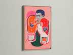 A close-up of the boxing legend canvas print in an oak frame. The artwork features a boxer with vibrant orange and pink colors. Perfect for gym wall decor or a sports bar. Add a touch of vintage art.