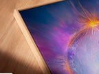 Here is an angled close up of a canvas print in a floating frame. The Yin Yang artwork showcases purple cosmic energy. It is ideal for meditation decor and spiritual wall art.