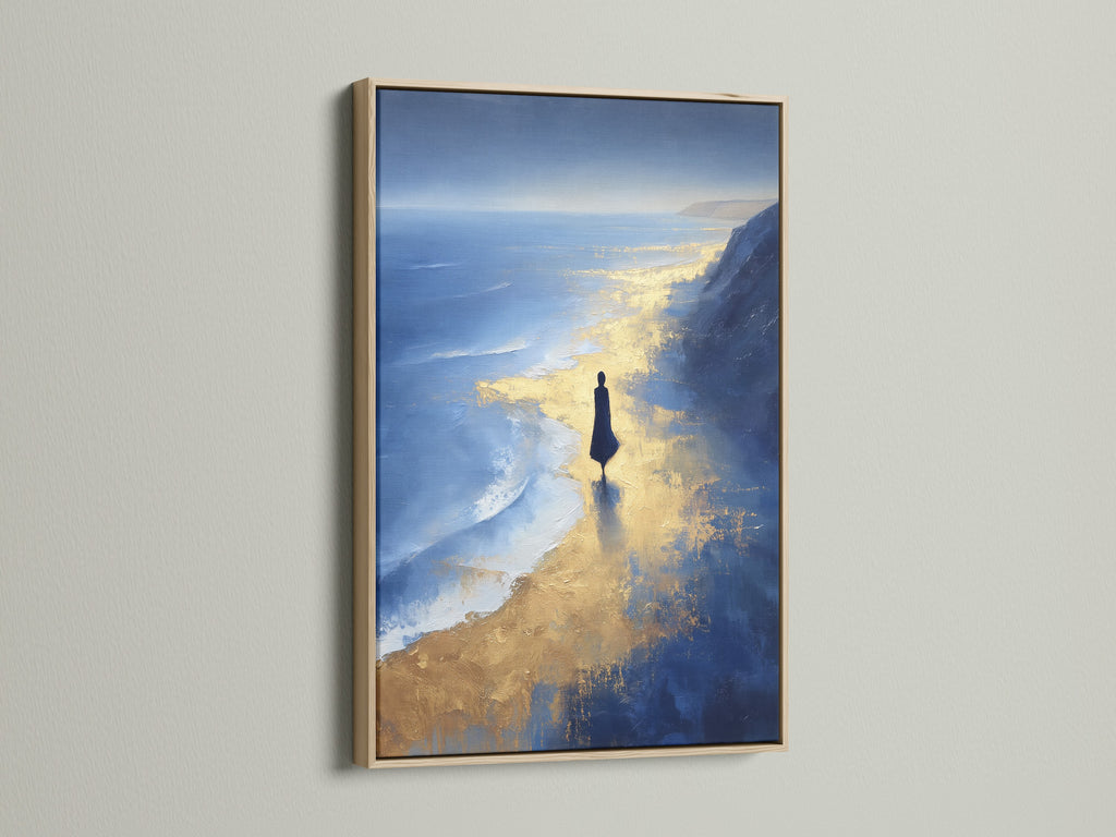 The Ocean Reflection art print is showcased in an oak frame. The blue and gold abstract design complements coastal styles. This beach canvas art brings a touch of the ocean to any room. Enhance your coastal wall decor with this abstract seascape.