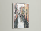 A white frame enhances this Venice Canal artwork. The watercolor print beautifully captures the European cityscape. It is ideal for creating an elegant atmosphere in living rooms and boutique hotels.