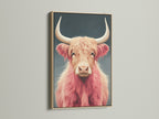 Pink Highland Cow art in an oak frame. The fluffy cattle art adds charm to any space. Perfect animal canvas art for farmhouse or Scandinavian decor. This Scottish cow decor is unique.