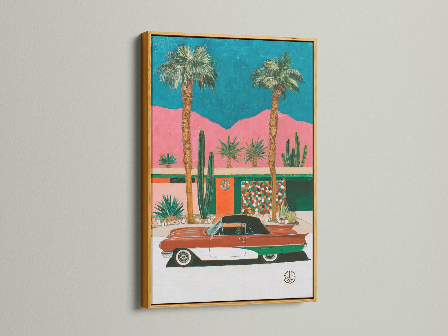 Retro Palm Springs artwork in a gold frame. The art is a mid-century modern desert scene. A vintage car adds a touch of nostalgia and elegance. The gold frame enhances the artwork's vibrant colors. It makes it a perfect statement piece for your home or office.