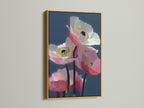 Framed pink poppy art is shown with a gold frame. The modern botanical art is a contemporary wall art piece. This floral canvas print is ideal for office wall art. The pink wall art adds a touch of sophistication. It is a stunning botanical artwork.