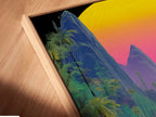 A close-up shot shows a canvas print in a floating frame. The tropical mountain artwork features a vibrant vaporwave sunset. This cyberpunk nature poster is perfect for modern decor. Add a touch of summer to your walls with this stunning piece.
