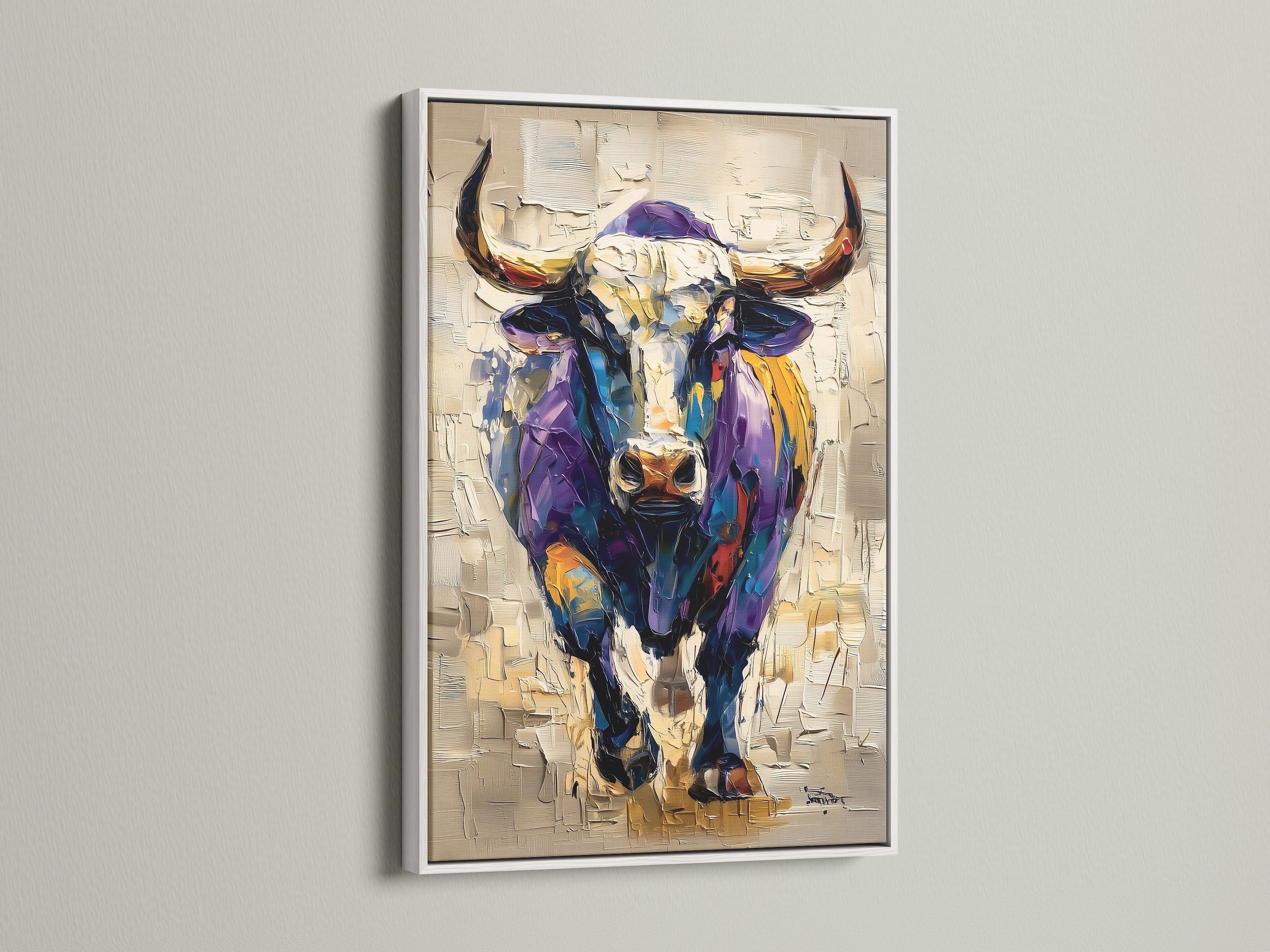 The artwork of a bull comes in a white frame. The white frame offers a clean and modern look. This artwork is versatile and fits any decor style. The bull is depicted in vibrant colors. Add a touch of sophistication to your living space with this piece.
