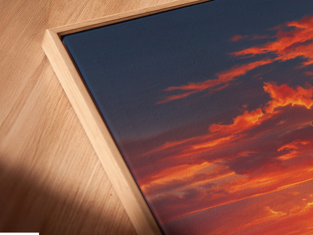 Angled close-up of a canvas print in a floating frame. The artwork features a serene windmill sunset. This enhances depth and brings a gallery-like feel to your wall art.