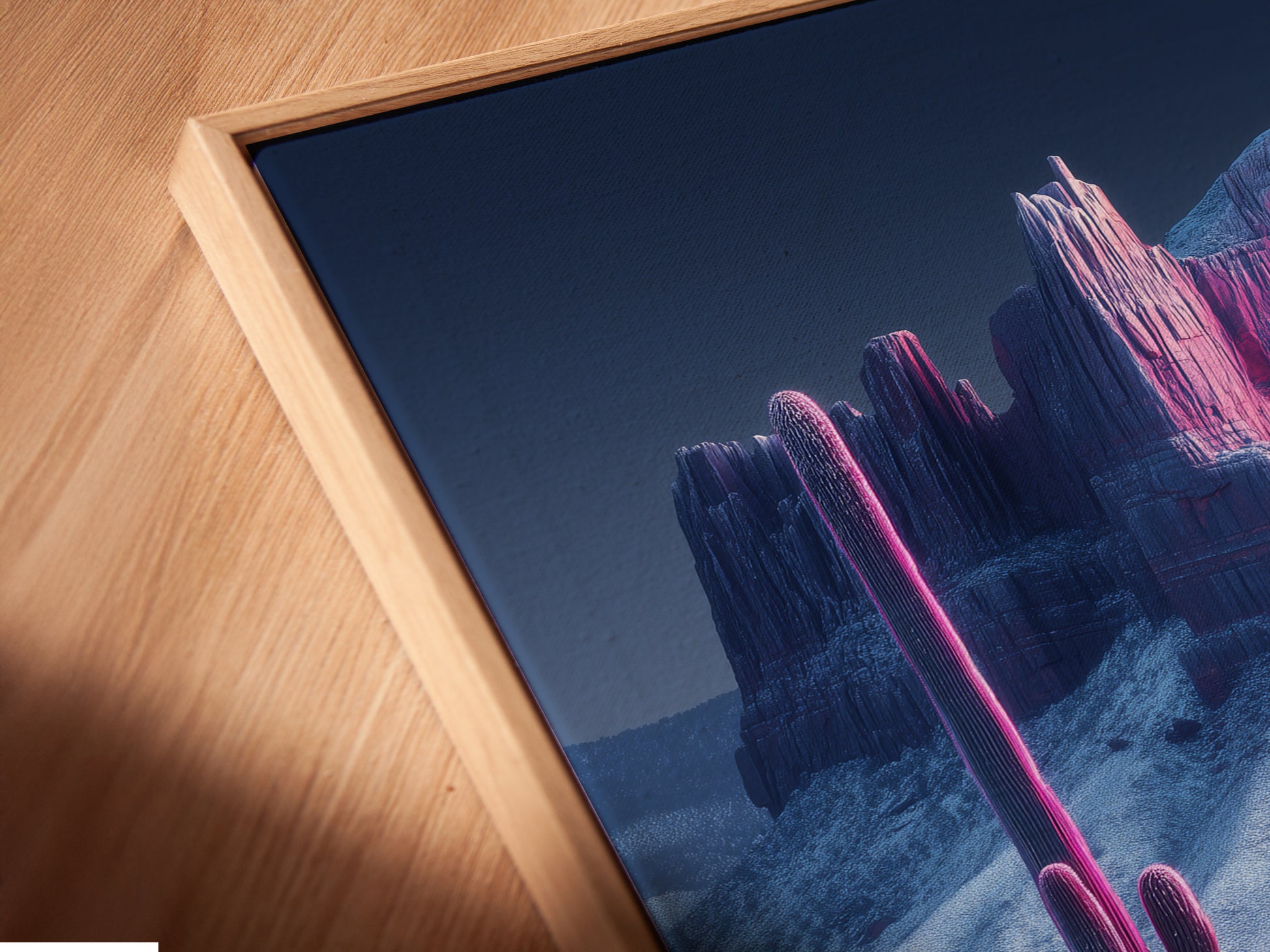 A close up of a canvas print in a floating frame. The modern Southwestern artwork features a pink cactus and mountain scene. The floating frame enhances the artwork. It makes it a focal point in any room.