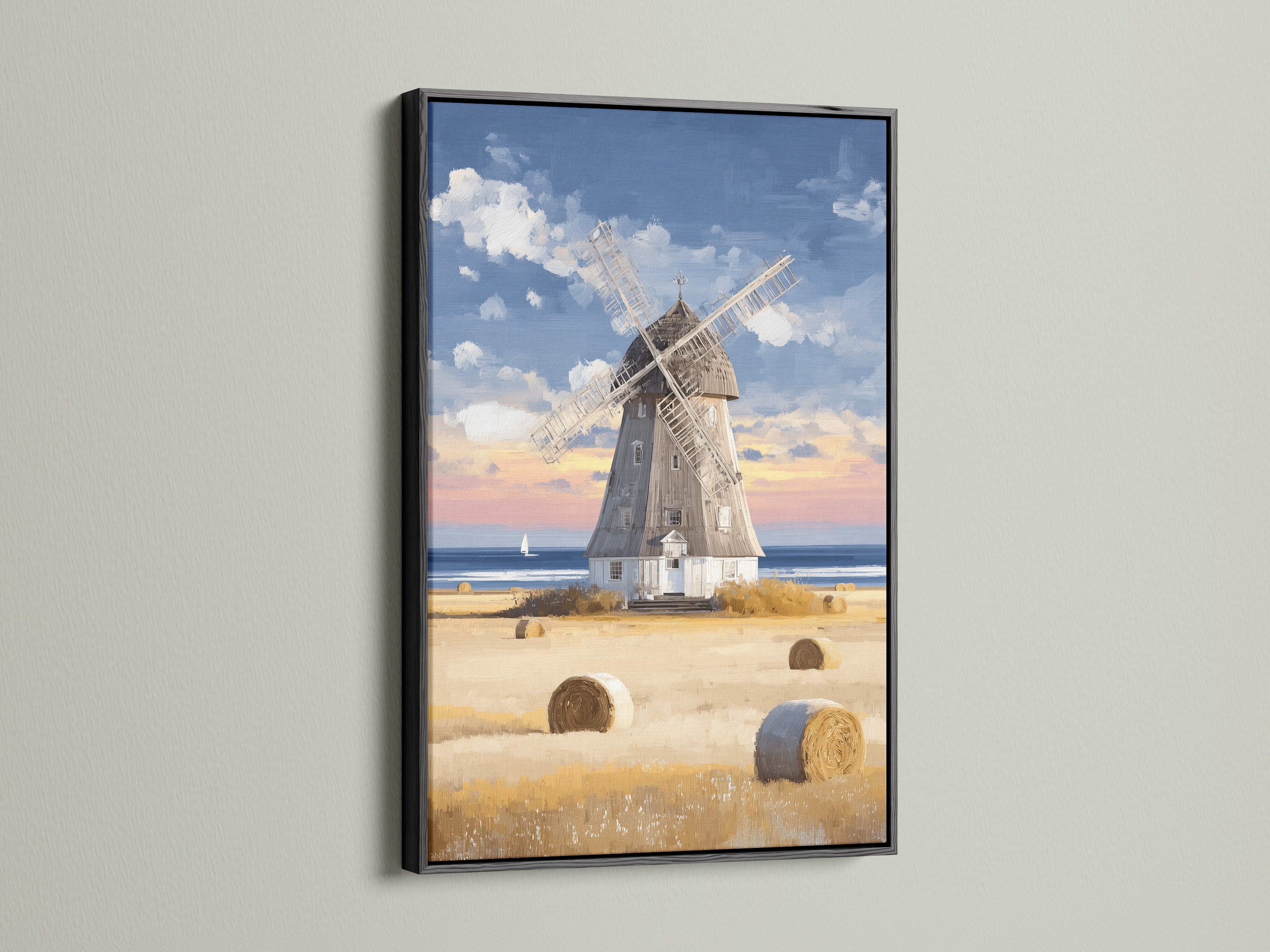 The striking contrast of a black frame enhances this windmill artwork. This artwork features a coastal countryside scene with hay bales. Perfect for adding a bold statement to your decor this framed art suits modern and rustic spaces. Bring vintage farmhouse charm and seaside tranquility to your home.
