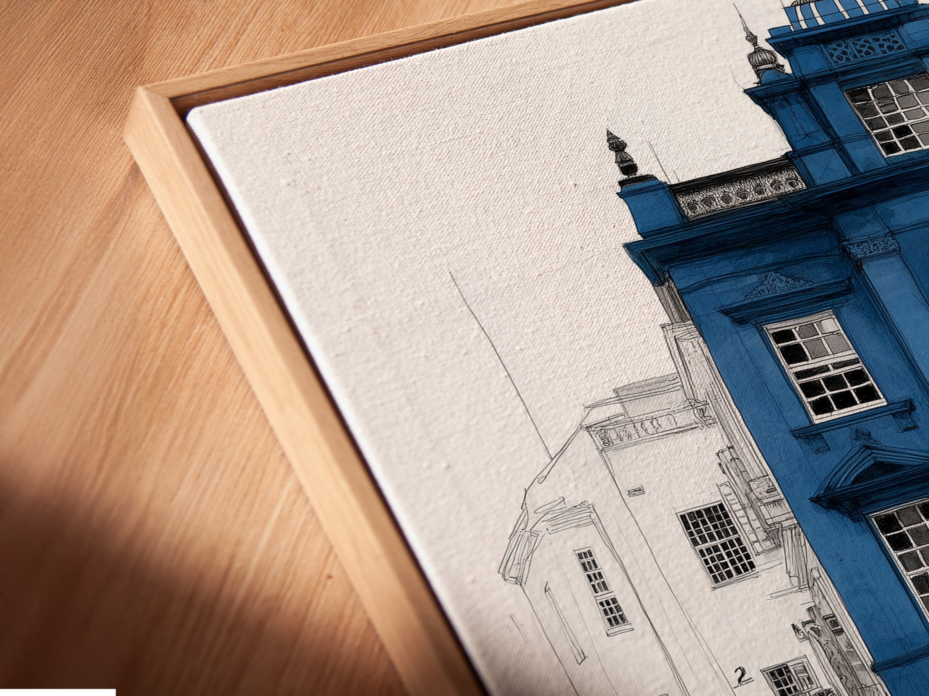 Close-up of a canvas print in a floating frame. The London Architecture Art features a blue building with a yellow door. This modern wall art is perfect for homeowners renters and interior designers. Enhance your space today.