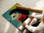 A woman is carefully rolling a fine art poster paper print of the hedgehog artwork. This whimsical animal canvas wall art is perfect for nursery decor. It is also great for kids' rooms. The colorful animal print adds a playful touch.