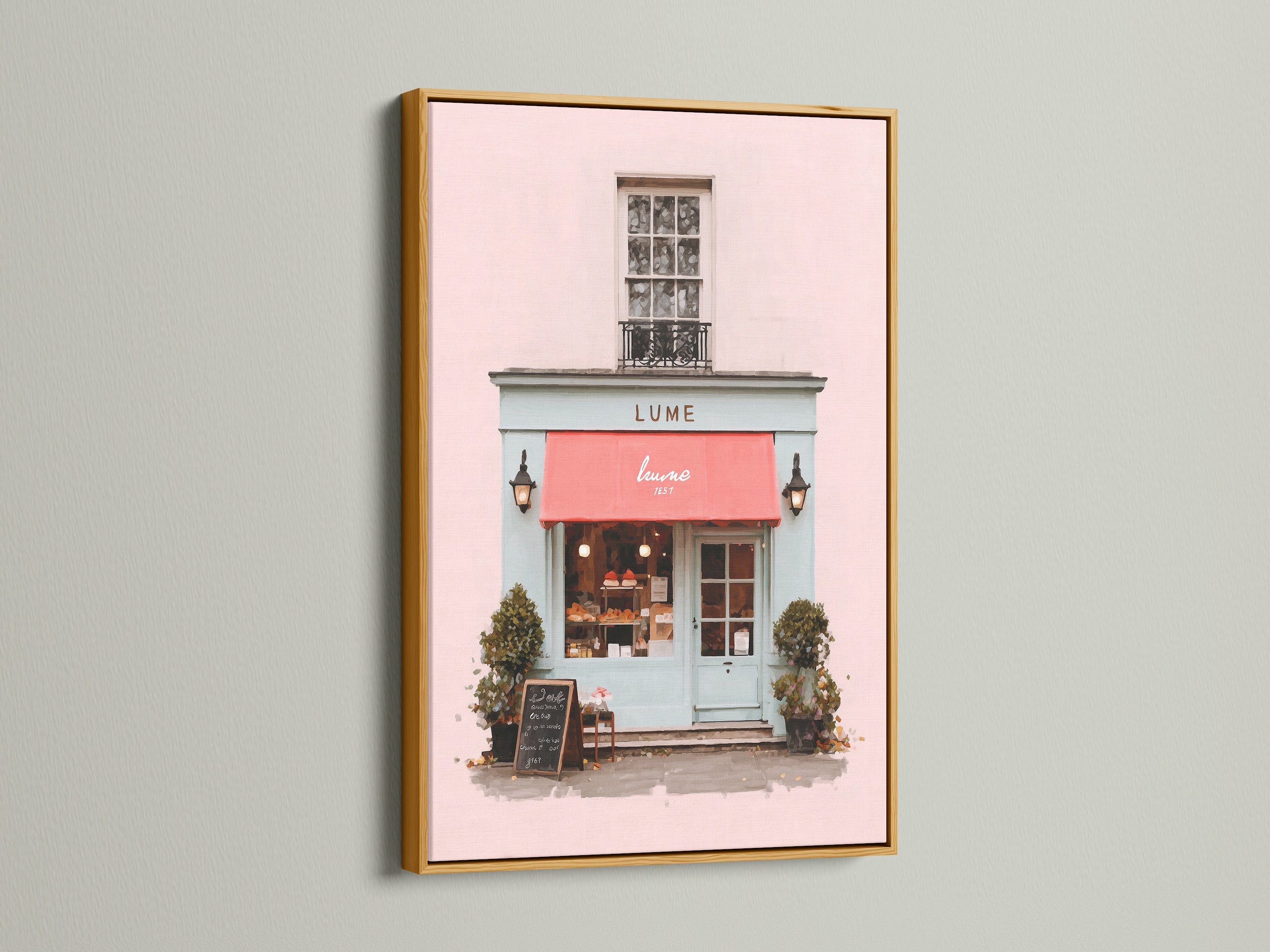 This beautiful art print is presented in a luxurious gold frame. The artwork features a charming building with a pink exterior and a vibrant red awning. The gold frame adds a touch of opulence and glamour. The piece enhances the artwork’s beauty. It is Ideal for adding a touch of luxury to your decor.