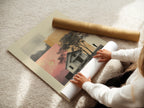 A woman rolls a fine art poster. This poster paper ensures high-quality prints. It allows for detailed art reproduction. Perfect for creating stunning displays. The rolling process protects the artwork. It preserves the poster's integrity.