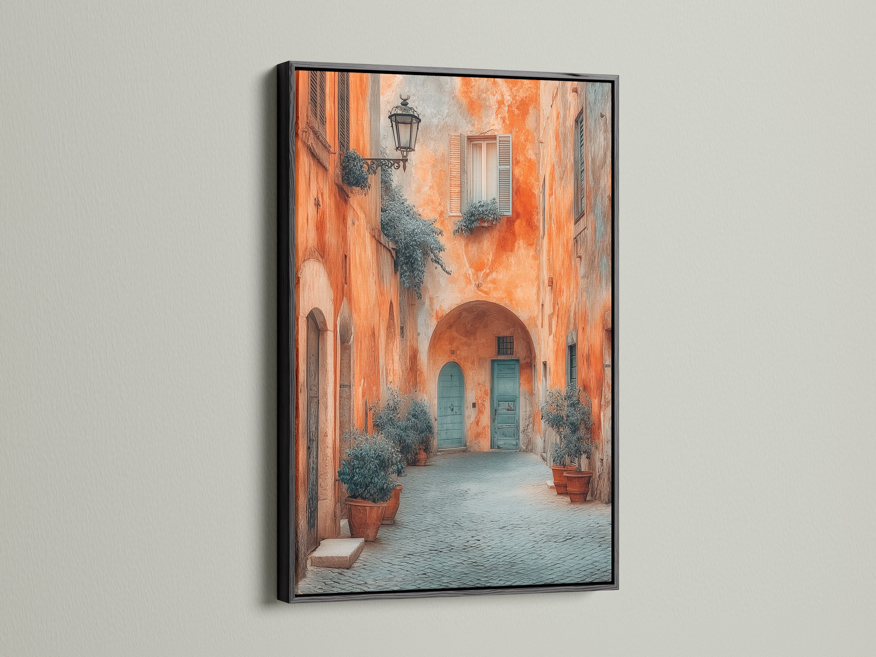 The Italian Alley artwork is displayed in a black frame. This Tuscan architecture wall art is perfect for homeowners renters interior designers and stagers. This European travel photography is perfect for minimalist and scandinavian styles. The blue door stands out