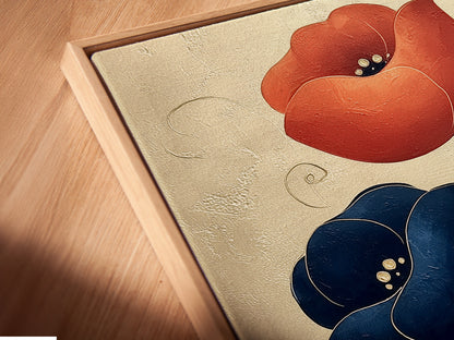 Close-up of a floral canvas art print in a floating frame. The navy blue and coral flowers stand out. This modern botanical artwork is perfect for adding a touch of nature to your space. The floating frame enhances the artwork.