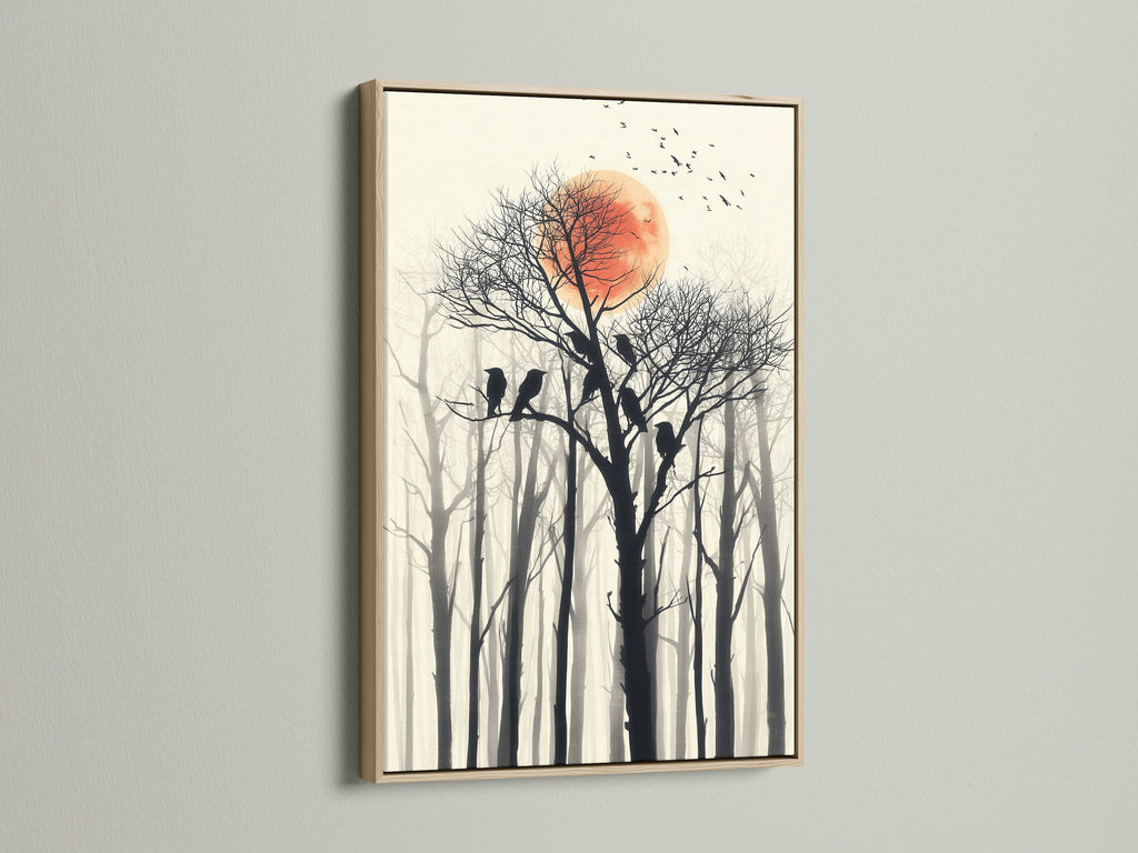 Birds on tree canvas print. This artwork features a red sun and a forest silhouette. The artwork is framed in an oak frame. It is ideal for homeowners and interior stylists seeking minimalist art.