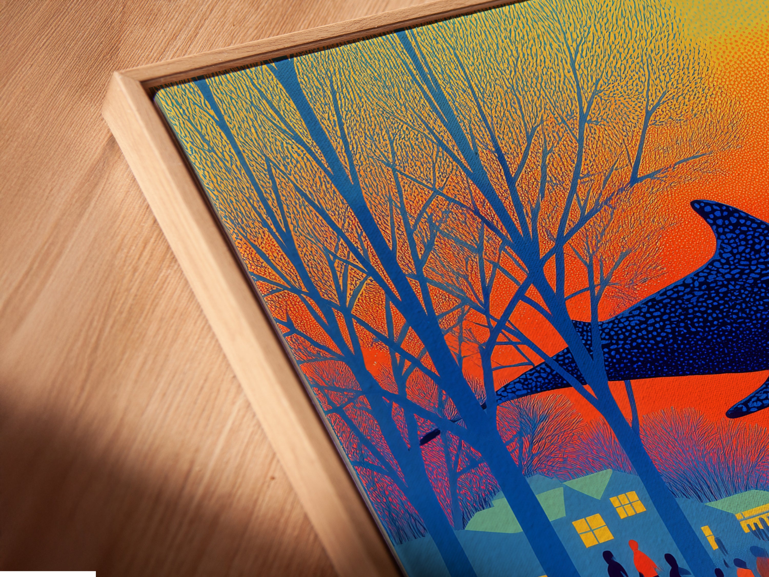 An angled close-up reveals a canvas print in a floating frame. The surreal whale artwork shows lakeside bicyclists in retro orange and blue. This unique framing style adds depth. This is perfect for eclectic styles. Enhance your space with this modern and vintage poster style art.