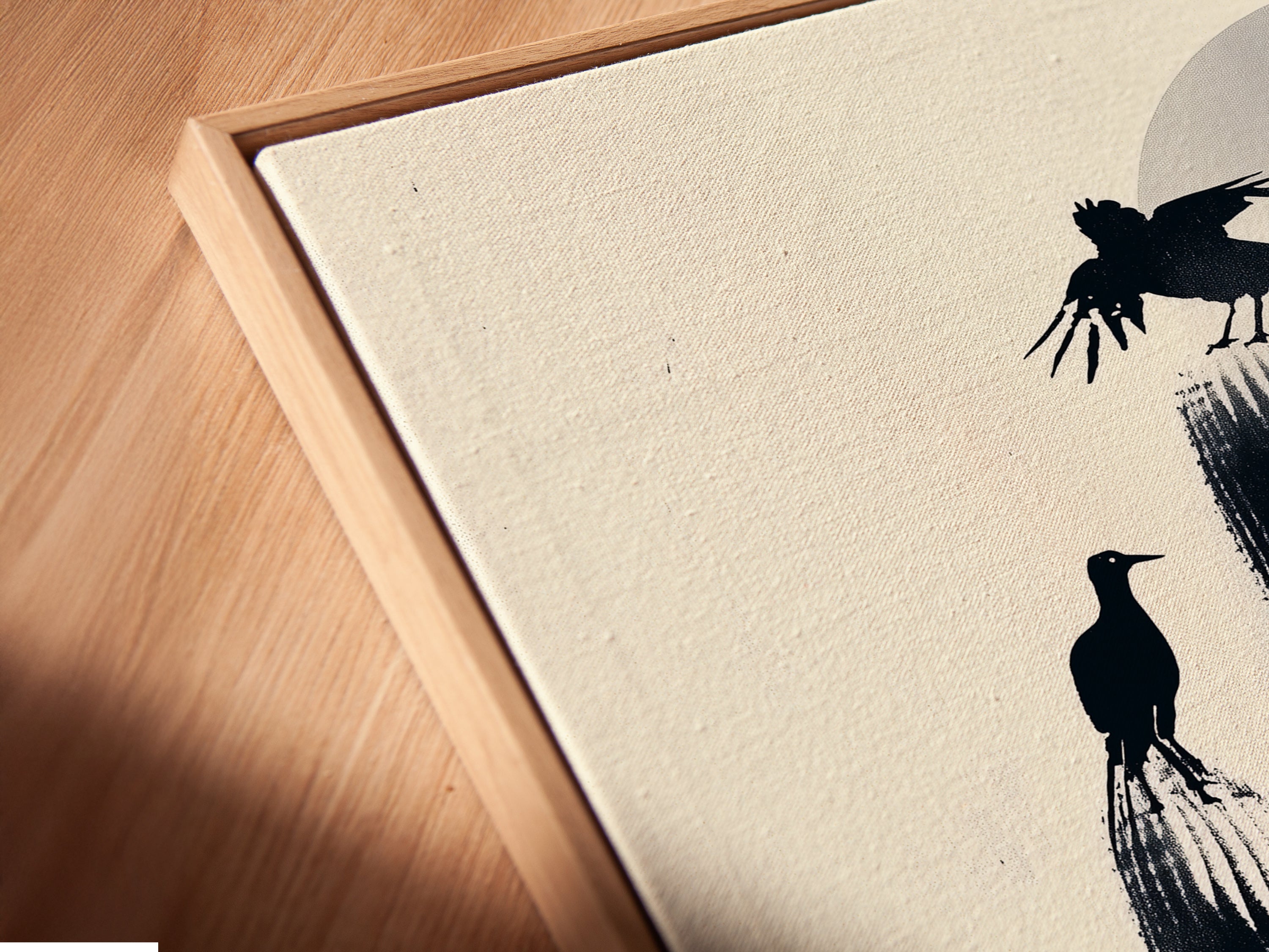 Angled close-up of a Cactus Birds canvas print in a floating frame. The desert silhouette artwork enhances your living space. A minimalist monochrome print featuring birds and a cactus. Perfect for southwestern decor.