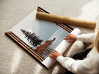 A woman is carefully rolling a fine art poster paper. This showcases the care taken in handling the mountain lake artwork. The nature view poster is prepared for shipping. Attention to detail ensures the artwork's quality.