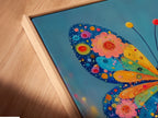 A close-up of the Butterfly Canvas Print in a floating frame. The colorful floral wall art is eye-catching. It is a whimsical piece for any space. The vibrant colors bring life to the artwork.