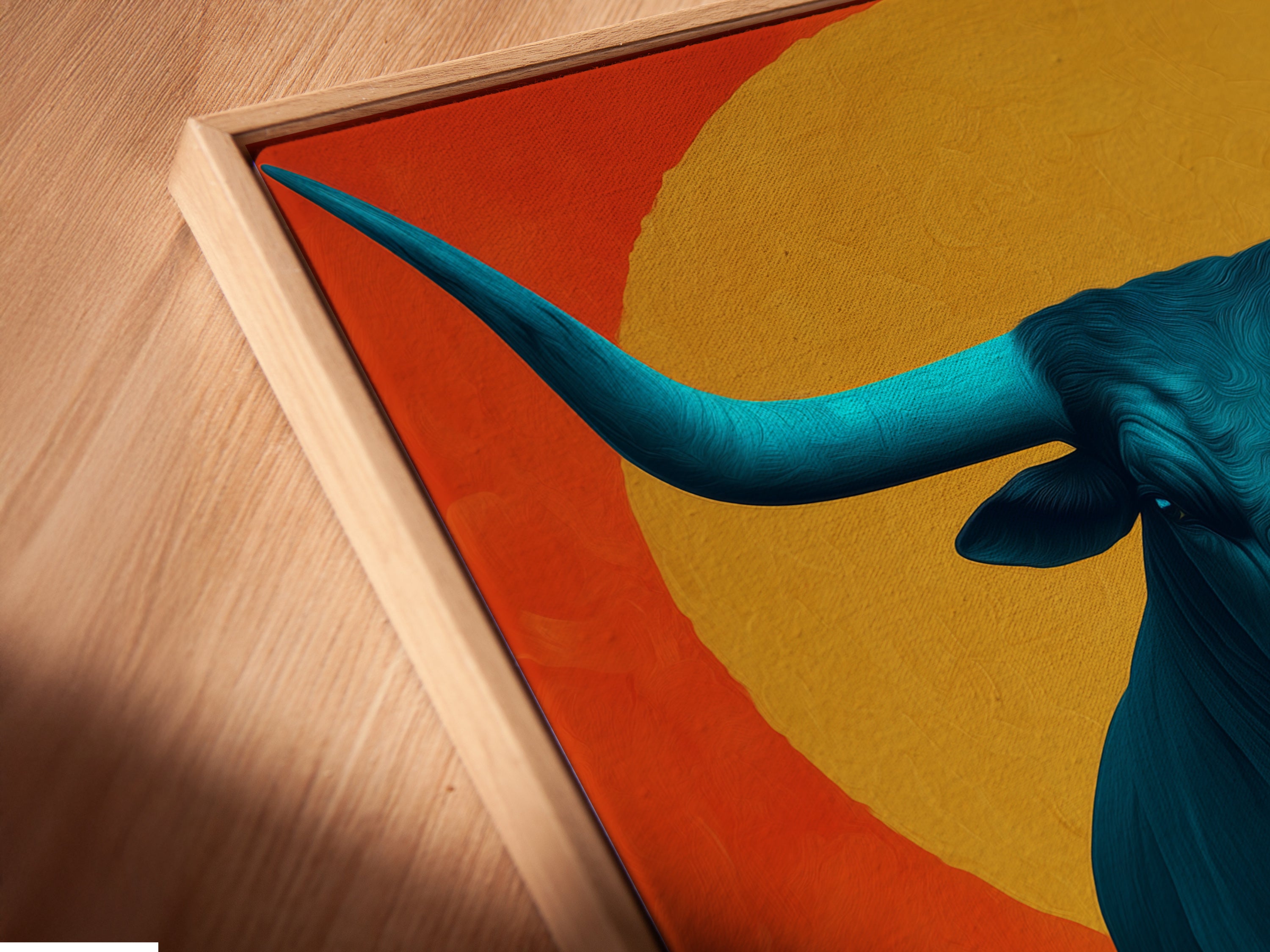 Get a detailed view of a canvas print in a floating frame. This artwork showcases the modern appeal of a teal bull print. Perfect for adding a touch of southwestern art to your home. The floating frame enhances the artwork's contemporary style.