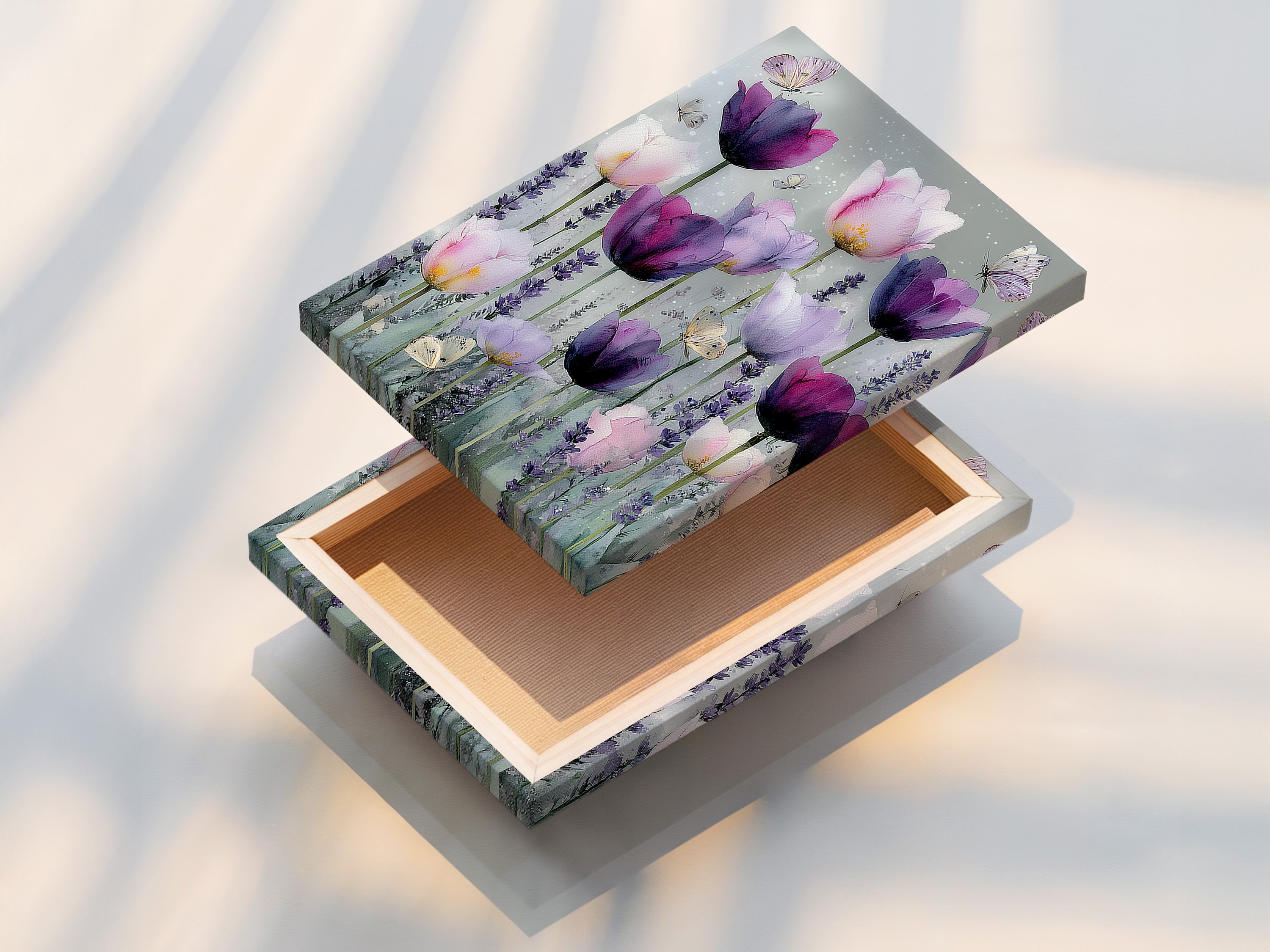 A stretched canvas print is displayed. The artwork features a vibrant display of pink and purple tulips. Butterflies flutter around the flowers. The stretched canvas gives the artwork a gallery-ready appearance. The print is taut and professionally presented enhancing its visual impact.