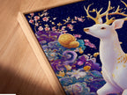A close-up view shows a canvas print in a floating frame. The white deer art is surrounded by a mystical forest and purple lotus flowers. Its contemporary style enhances any room's aesthetic appeal