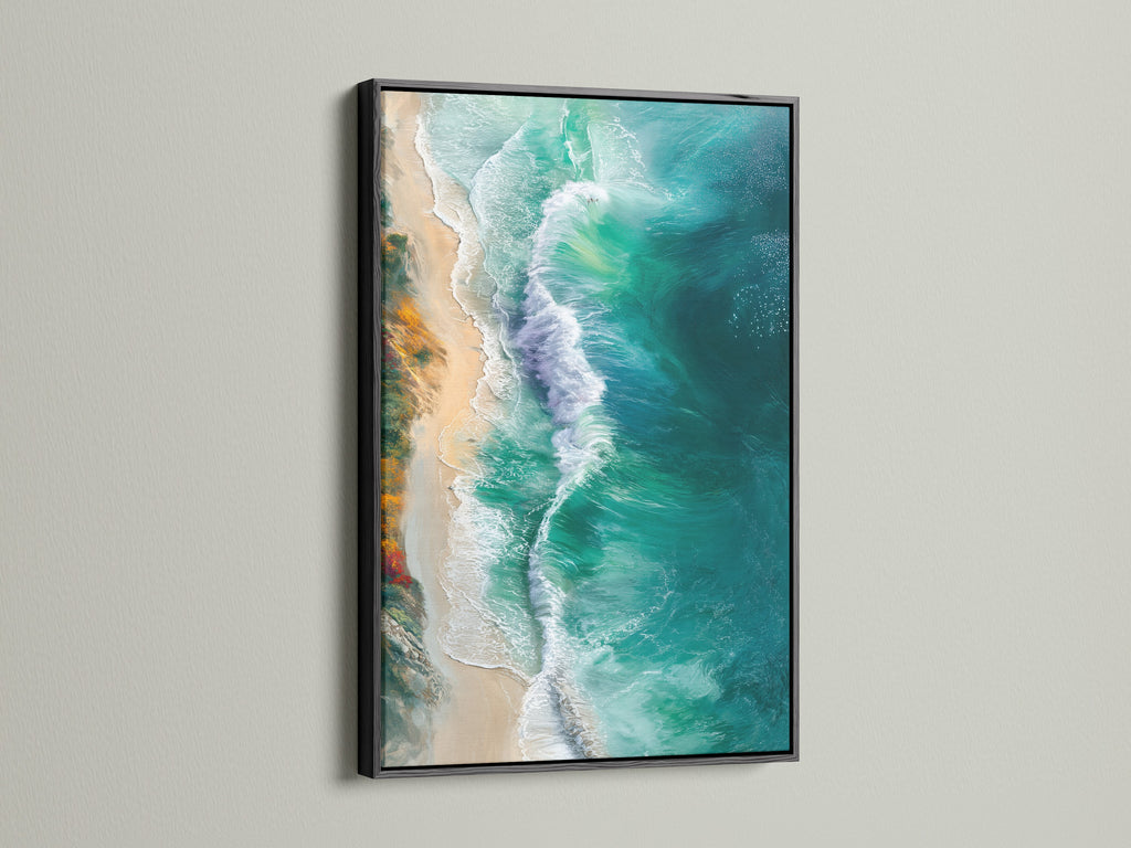 The ocean waves canvas print is showcased in a black frame. This provides a striking contrast. The artwork features aerial photography of turquoise teal waves. A great piece for coastal themed interiors.