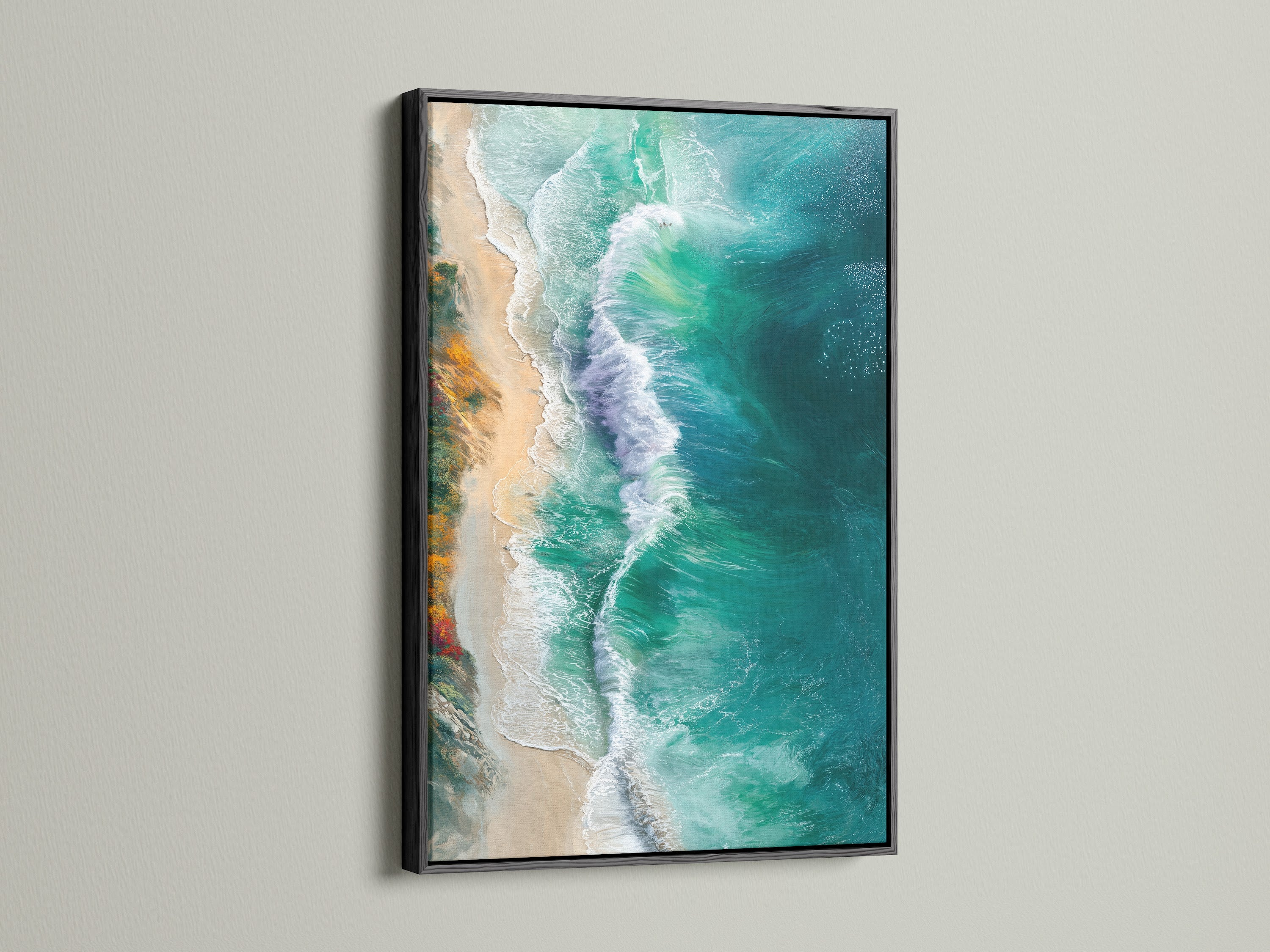 The ocean waves canvas print is showcased in a black frame. This provides a striking contrast. The artwork features aerial photography of turquoise teal waves. A great piece for coastal themed interiors.
