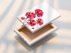 A stretched canvas print of a red floral artwork is showcased. This flower wall art is ready to hang. The botanical print adds a vibrant touch. The crimson blossoms bring life to any room with this flower artwork.